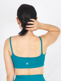 Top deportivo femenino esencial verde azul